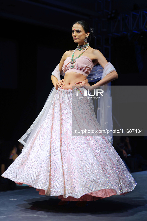 A model walks the ramp showcasing a designer collection during the 'Shaadiyan' season-5 fashion show in Jaipur, Rajasthan, India, on October...