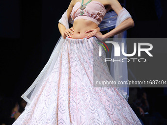 A model walks the ramp showcasing a designer collection during the 'Shaadiyan' season-5 fashion show in Jaipur, Rajasthan, India, on October...