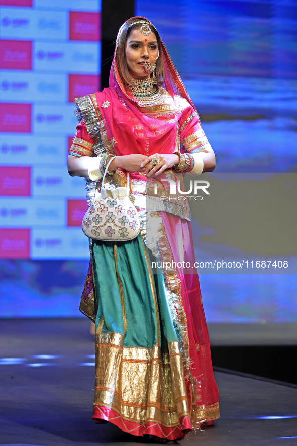 A model walks the ramp showcasing a designer collection during the 'Shaadiyan' season-5 fashion show in Jaipur, Rajasthan, India, on October...