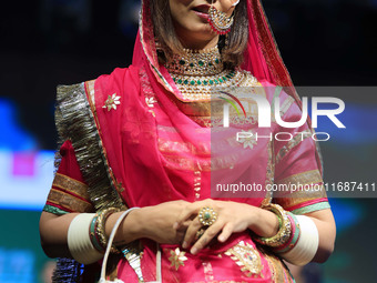 A model walks the ramp showcasing a designer collection during the 'Shaadiyan' season-5 fashion show in Jaipur, Rajasthan, India, on October...