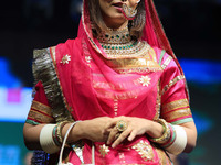 A model walks the ramp showcasing a designer collection during the 'Shaadiyan' season-5 fashion show in Jaipur, Rajasthan, India, on October...