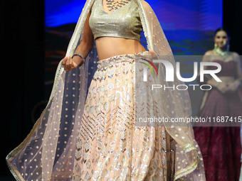 A model walks the ramp showcasing a designer collection during the 'Shaadiyan' season-5 fashion show in Jaipur, Rajasthan, India, on October...