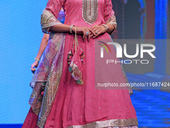 A model walks the ramp showcasing a designer collection during the 'Shaadiyan' season-5 fashion show in Jaipur, Rajasthan, India, on October...