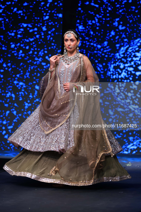 A model walks the ramp showcasing a designer collection during the 'Shaadiyan' season-5 fashion show in Jaipur, Rajasthan, India, on October...