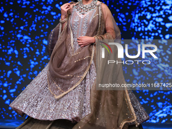 A model walks the ramp showcasing a designer collection during the 'Shaadiyan' season-5 fashion show in Jaipur, Rajasthan, India, on October...