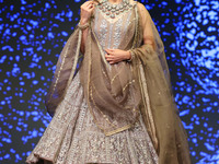 A model walks the ramp showcasing a designer collection during the 'Shaadiyan' season-5 fashion show in Jaipur, Rajasthan, India, on October...