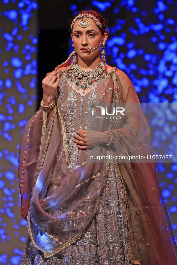 A model walks the ramp showcasing a designer collection during the 'Shaadiyan' season-5 fashion show in Jaipur, Rajasthan, India, on October...