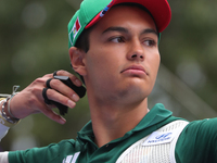 Matias Grande of Mexico competes against Kim Woojin of Korea (not in picture) during the Men's recurve semifinals match on the final day of...