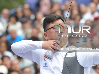 Kim Woojin of Korea competes against Matias Grande of Mexico (not in picture) during the Men's recurve semifinals match on the final day of...