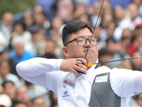 Kim Woojin of Korea competes against Matias Grande of Mexico (not in picture) during the Men's recurve semifinals match on the final day of...