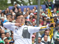 Kim Woojin of Korea competes against Matias Grande of Mexico (not in picture) during the Men's recurve semifinals match on the final day of...