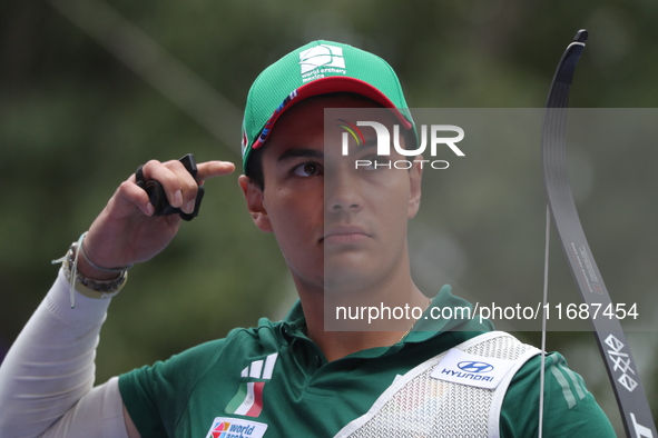 Matias Grande of Mexico competes against Kim Woojin of Korea (not in picture) during the Men's recurve semifinals match on the final day of...