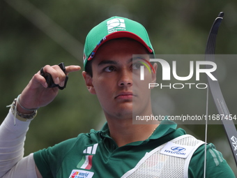 Matias Grande of Mexico competes against Kim Woojin of Korea (not in picture) during the Men's recurve semifinals match on the final day of...