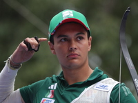 Matias Grande of Mexico competes against Kim Woojin of Korea (not in picture) during the Men's recurve semifinals match on the final day of...