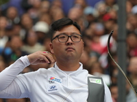 Kim Woojin of Korea competes against Matias Grande of Mexico (not in picture) during the Men's recurve semifinals match on the final day of...