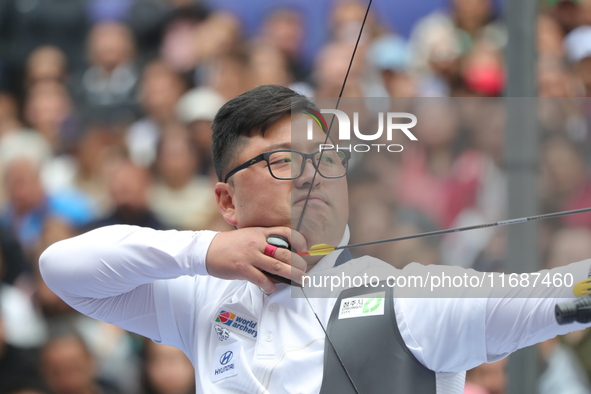 Kim Woojin of Korea competes against Matias Grande of Mexico (not in picture) during the Men's recurve semifinals match on the final day of...