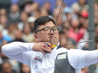 Kim Woojin of Korea competes against Matias Grande of Mexico (not in picture) during the Men's recurve semifinals match on the final day of...