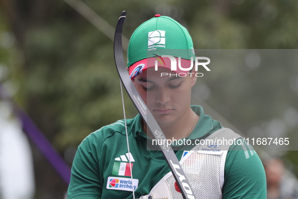 Matias Grande of Mexico competes against Kim Woojin of Korea (not in picture) during the Men's recurve semifinals match on the final day of...