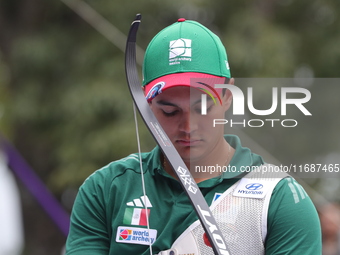 Matias Grande of Mexico competes against Kim Woojin of Korea (not in picture) during the Men's recurve semifinals match on the final day of...