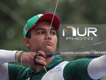 Matias Grande of Mexico competes against Kim Woojin of Korea (not in picture) during the Men's recurve semifinals match on the final day of...