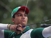 Matias Grande of Mexico competes against Kim Woojin of Korea (not in picture) during the Men's recurve semifinals match on the final day of...