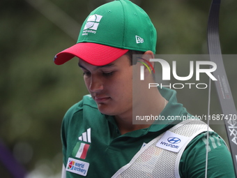 Matias Grande of Mexico competes against Kim Woojin of Korea (not in picture) during the Men's recurve semifinals match on the final day of...