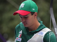 Matias Grande of Mexico competes against Kim Woojin of Korea (not in picture) during the Men's recurve semifinals match on the final day of...