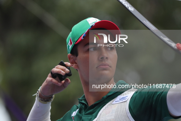 Matias Grande of Mexico competes against Kim Woojin of Korea (not in picture) during the Men's recurve semifinals match on the final day of...