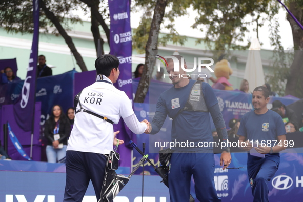 Lee Woo-Seok of Korea and Marcus D'Almeida of Brazil compete during the Men's recurve semifinals match on the final day of the Tlaxcala 2024...