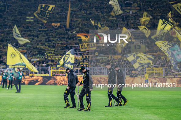 Workers check the pitch before the Bundesliga match between Borussia Dortmund and FC St. Pauli 1910 at Signal Iduna Park in Dortmund, German...