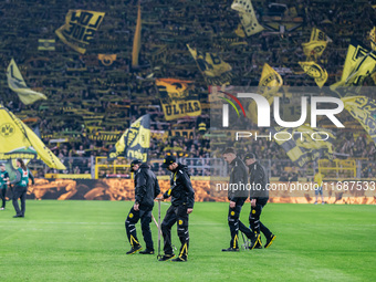 Workers check the pitch before the Bundesliga match between Borussia Dortmund and FC St. Pauli 1910 at Signal Iduna Park in Dortmund, German...