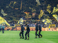 Workers check the pitch before the Bundesliga match between Borussia Dortmund and FC St. Pauli 1910 at Signal Iduna Park in Dortmund, German...