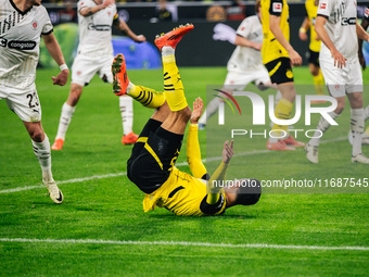 Ramy Bensebaini of Borussia Dortmund falls down during the Bundesliga match between Borussia Dortmund and FC St. Pauli 1910 at Signal Iduna...