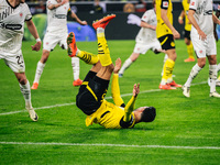 Ramy Bensebaini of Borussia Dortmund falls down during the Bundesliga match between Borussia Dortmund and FC St. Pauli 1910 at Signal Iduna...