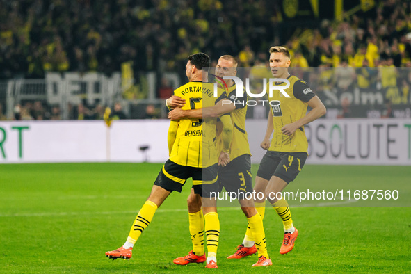 Ramy Bensebaini of Borussia Dortmund celebrates his goal with teammates during the Bundesliga match between Borussia Dortmund and FC St. Pau...