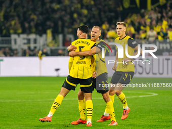 Ramy Bensebaini of Borussia Dortmund celebrates his goal with teammates during the Bundesliga match between Borussia Dortmund and FC St. Pau...