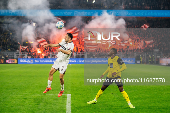 Jamie Bynoe-Gittens of Borussia Dortmund plays against Manolis Saliakas of FC St. Pauli during the Bundesliga match between Borussia Dortmun...