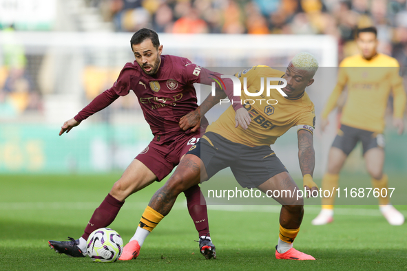 Mario Lemina of Wolves and Bernardo Silva of Manchester City are in action during the Premier League match between Wolverhampton Wanderers a...