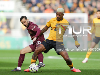 Mario Lemina of Wolves and Bernardo Silva of Manchester City are in action during the Premier League match between Wolverhampton Wanderers a...