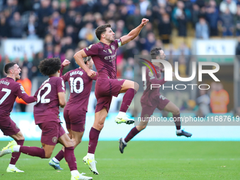 Manchester City's players celebrate after their second goal, scored by John Stones, is confirmed by VAR during the Premier League match betw...