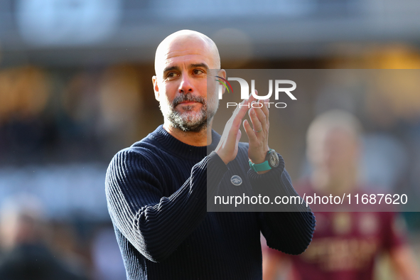 Manchester City's manager Pep Guardiola applauds their traveling support during the Premier League match between Wolverhampton Wanderers and...