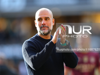 Manchester City's manager Pep Guardiola applauds their traveling support during the Premier League match between Wolverhampton Wanderers and...