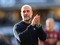 Manchester City's manager Pep Guardiola applauds their traveling support during the Premier League match between Wolverhampton Wanderers and...