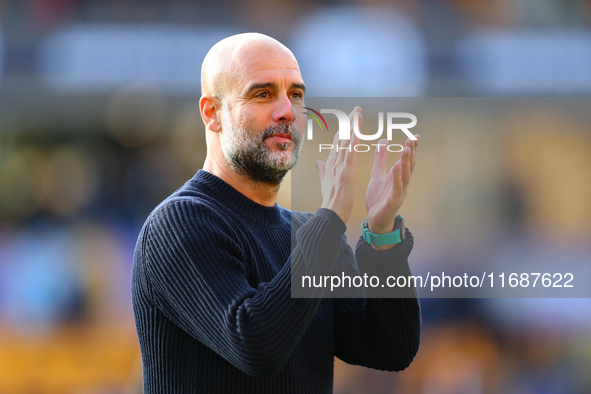 Manchester City's manager Pep Guardiola applauds their traveling support during the Premier League match between Wolverhampton Wanderers and...