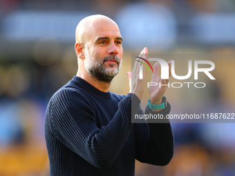 Manchester City's manager Pep Guardiola applauds their traveling support during the Premier League match between Wolverhampton Wanderers and...