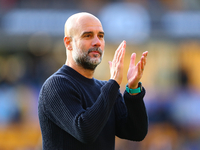 Manchester City's manager Pep Guardiola applauds their traveling support during the Premier League match between Wolverhampton Wanderers and...