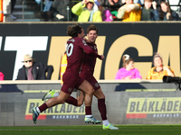 John Stones of Manchester City celebrates with Jack Grealish after scoring his side's second goal during the Premier League match between Wo...