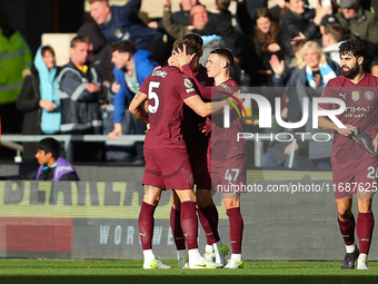 John Stones of Manchester City celebrates with Phil Foden after scoring his side's second goal during the Premier League match between Wolve...