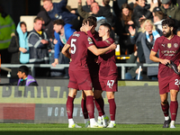 John Stones of Manchester City celebrates with Phil Foden after scoring his side's second goal during the Premier League match between Wolve...