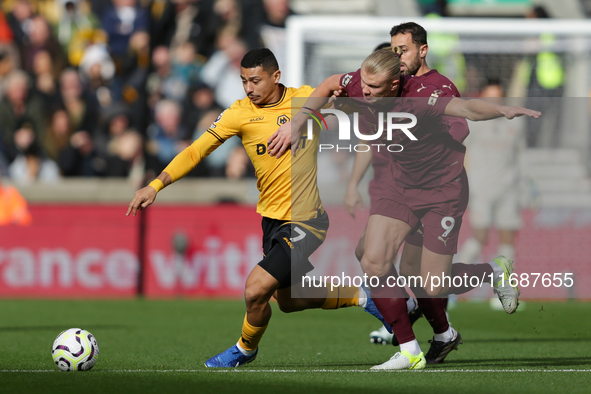 Andre of Wolves battles for possession with Erling Haaland of Manchester City during the Premier League match between Wolverhampton Wanderer...